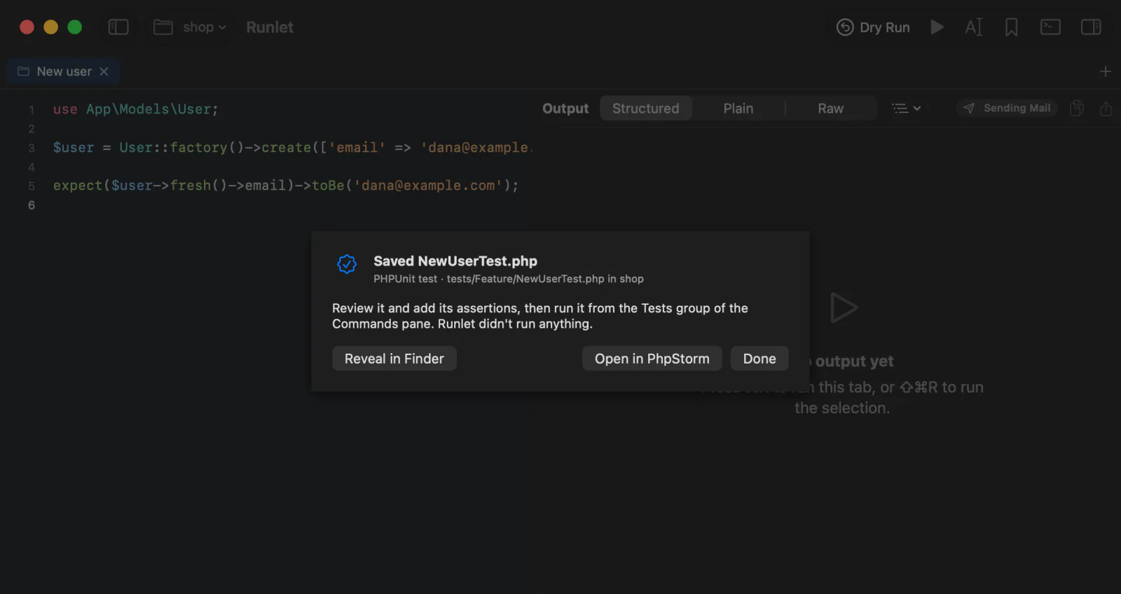 The sheet after Save as Test…: NewUserTest.php saved in tests/Feature of the shop project, with Reveal in Finder, Open in PhpStorm, and Done