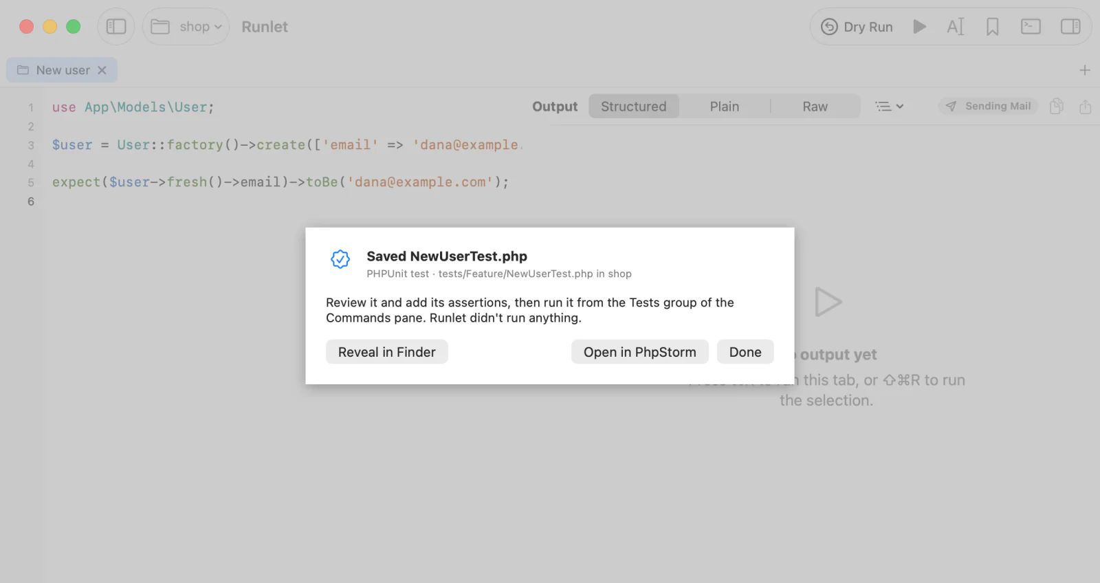 The sheet after Save as Test…: NewUserTest.php saved in tests/Feature of the shop project, with Reveal in Finder, Open in PhpStorm, and Done